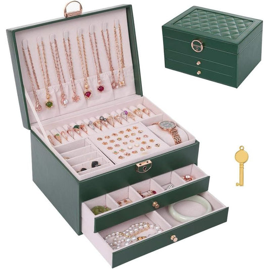 A dark green jewelry box shown open with multiple compartments filled with necklaces, rings, earrings, bracelets, and a watch, plus a small key. A smaller closed view of the same box appears in the upper right on a clean white background.