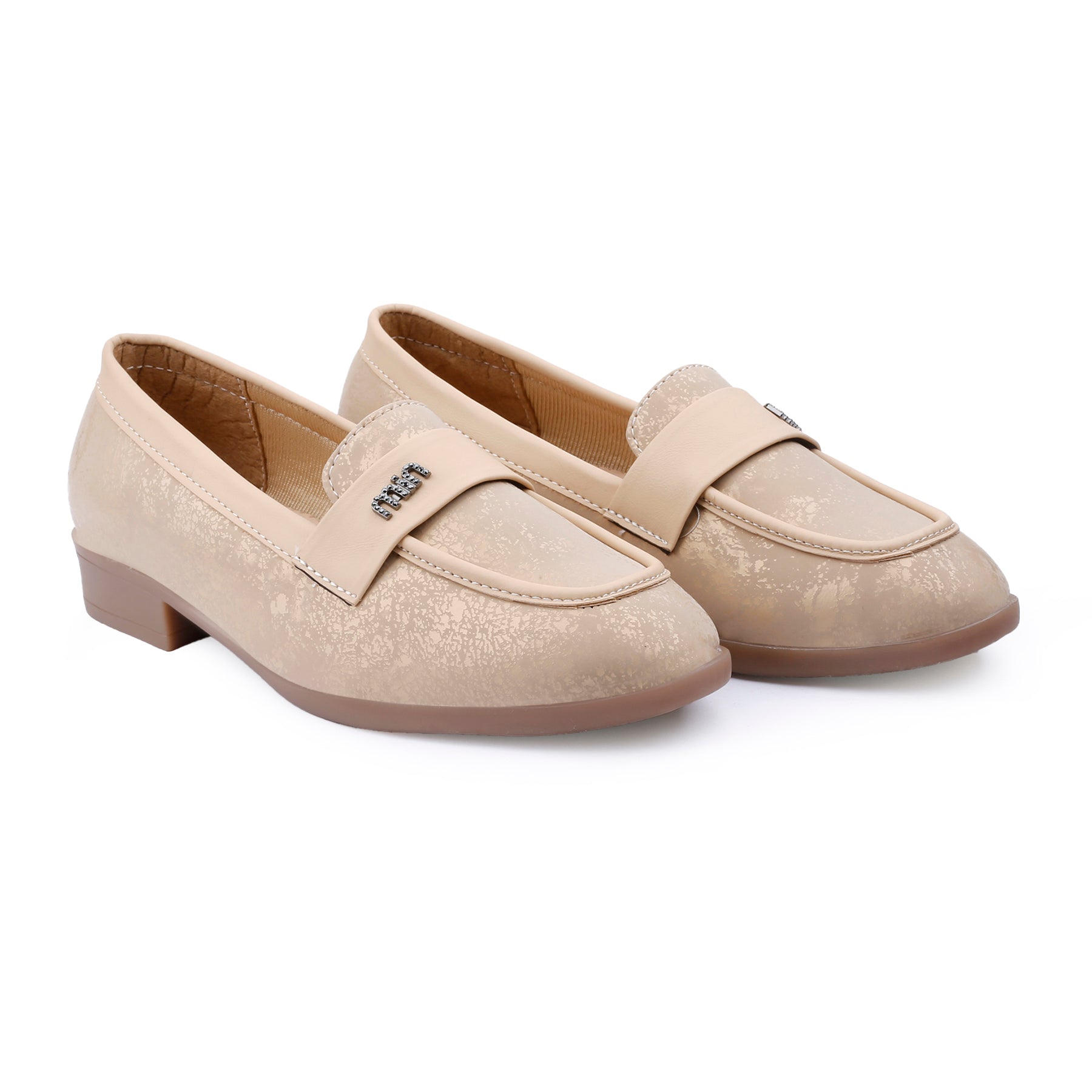 A pair of women's beige slip-on loafers with a subtle textured pattern, low block heels, and a decorative strap across the instep, shown on a plain white background.