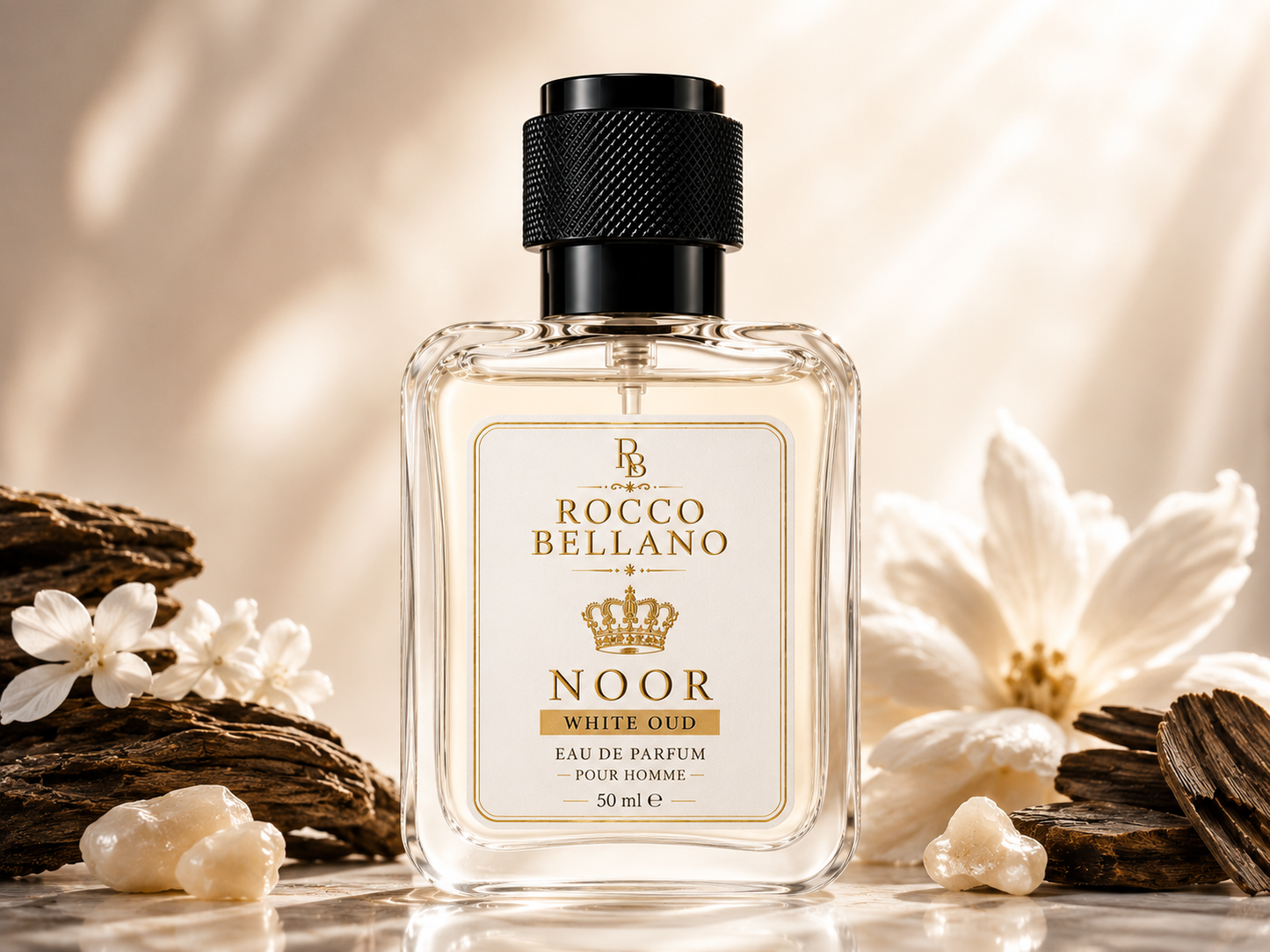 Rocco Bellano Noor White Oud perfume bottle with flowers and rocks on a beige background