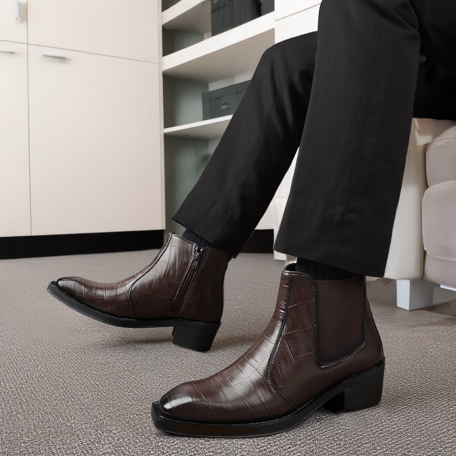 Person wearing brown leather boots in an office setting