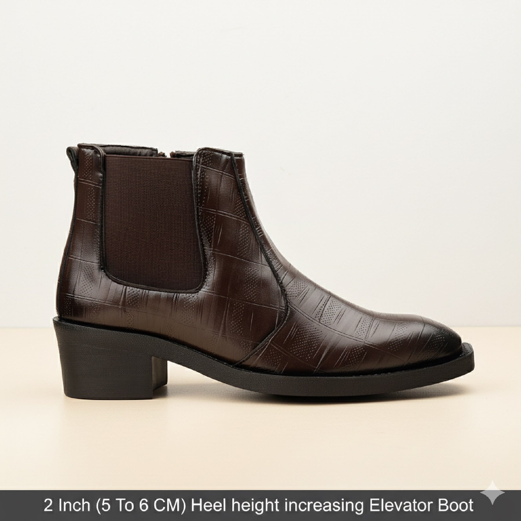 Brown leather boot with a 2-inch heel on a beige background