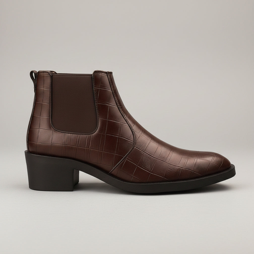 Brown leather boot with crocodile texture on a wooden background