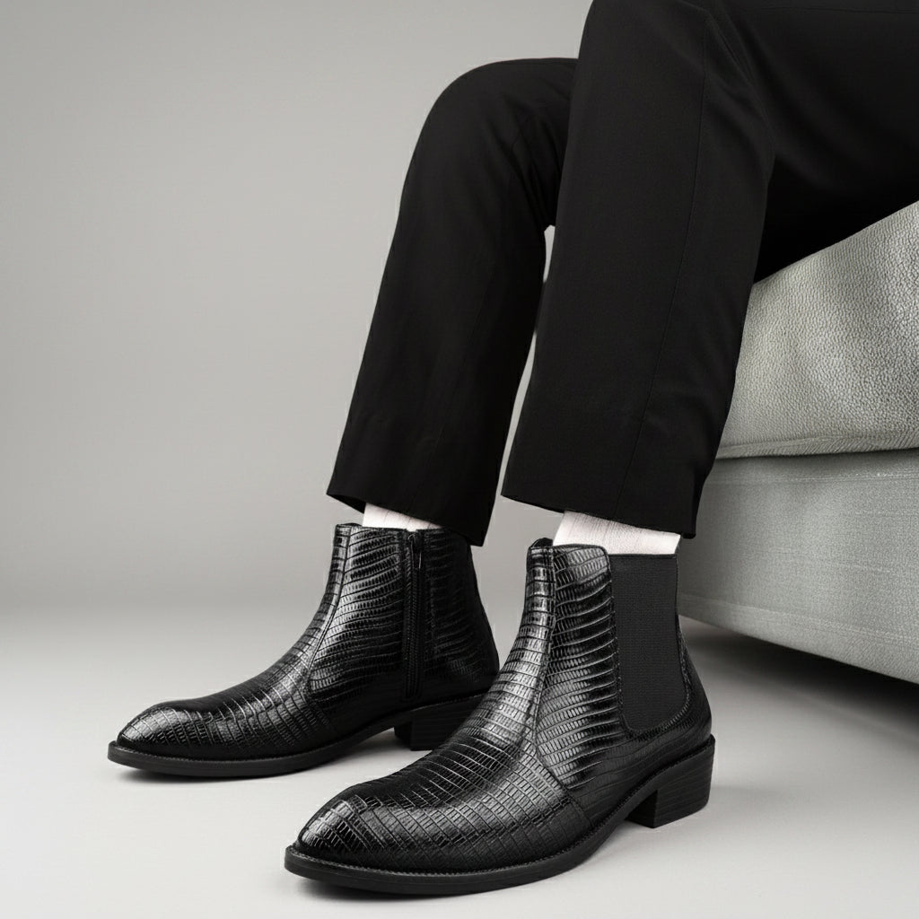 Person wearing black textured ankle boots in a modern indoor setting.
