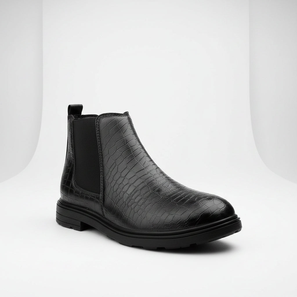 Black crocodile-patterned Chelsea boot on a white background