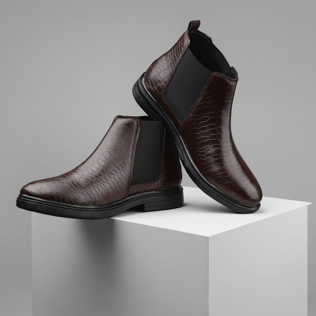 Brown leather boots with black soles on a beige platform against a beige background
