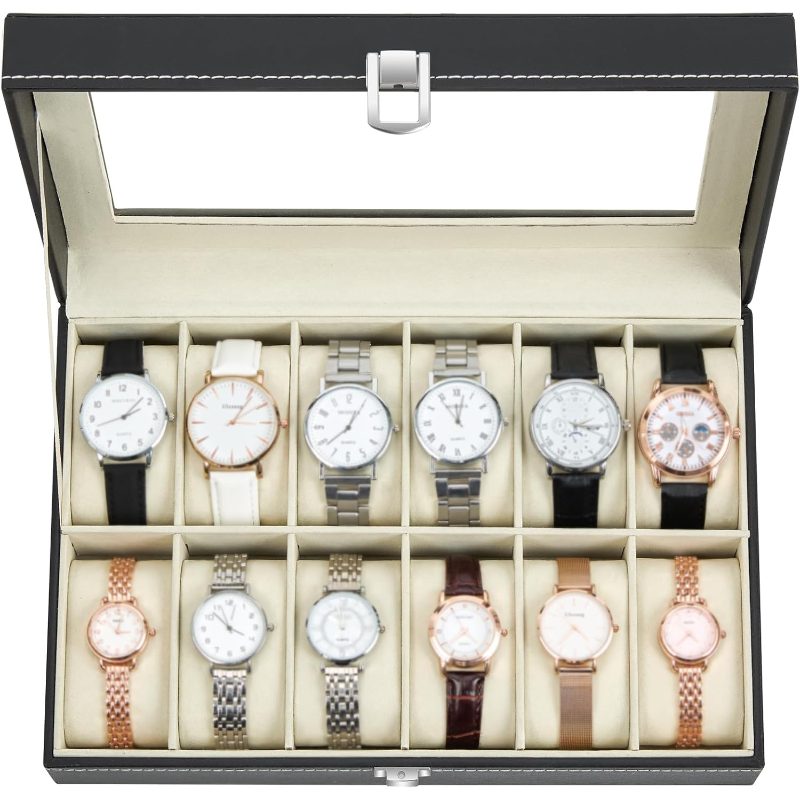 A black watch storage box with a clear glass lid, shown open to display 12 wristwatches arranged in two rows of six on a beige cushioned interior.