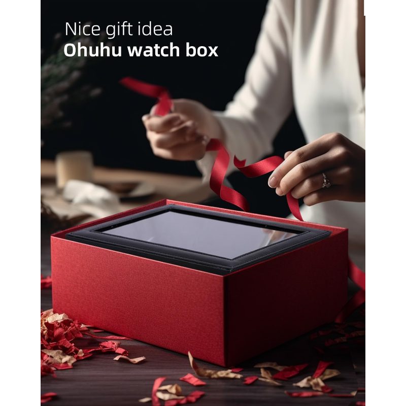 A red gift box with a clear window lid sits on a dark table, with a person's hands and torso visible behind it handling a red ribbon. White text at the top reads 'Nice gift idea Ohuhu watch box.