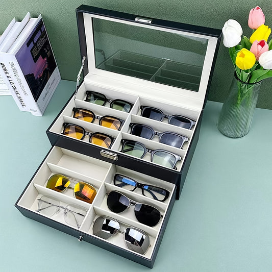 Sunglasses organizer with multiple compartments on a light blue surface with flowers and books in the background.