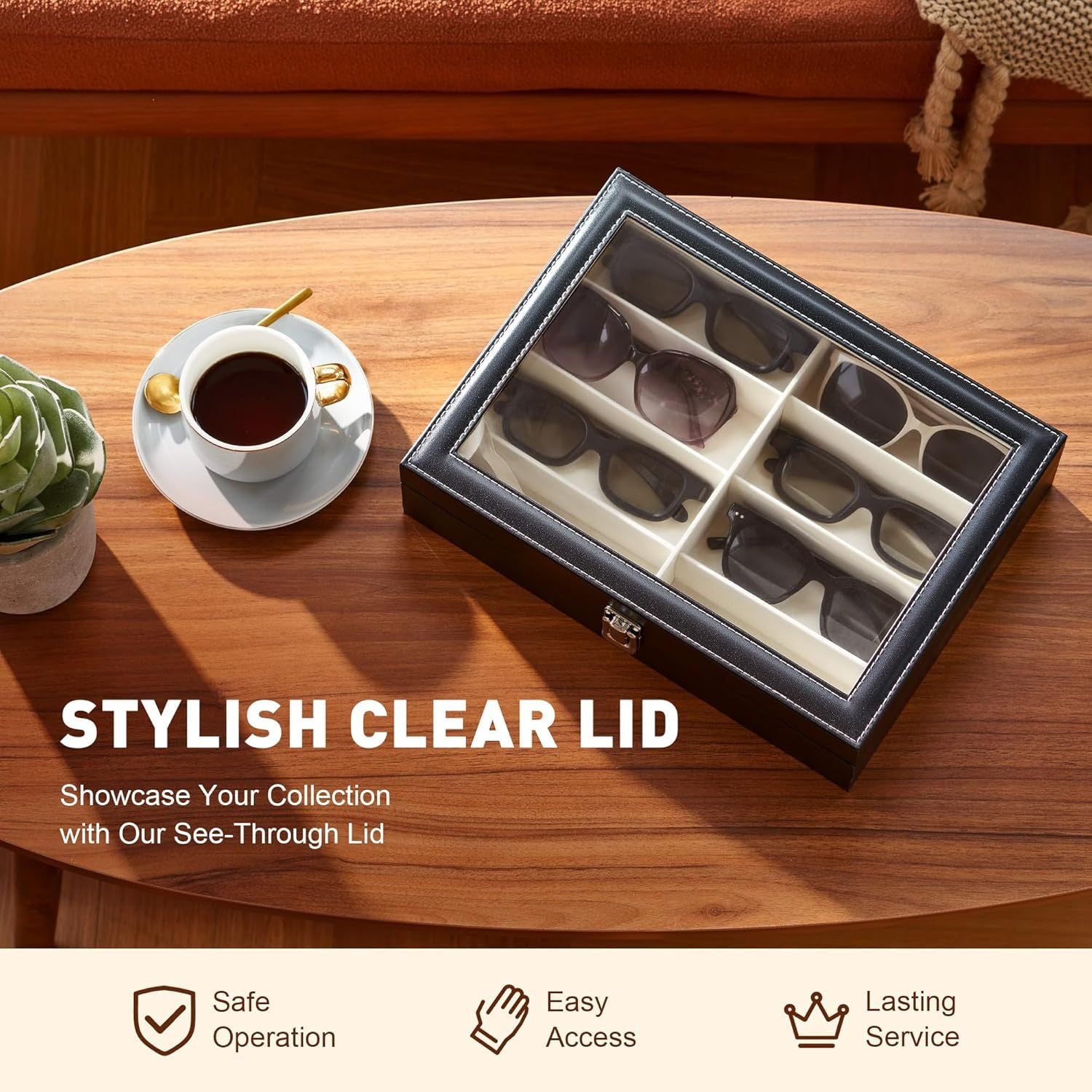 Display case with clear lid on a wooden table next to a cup of coffee