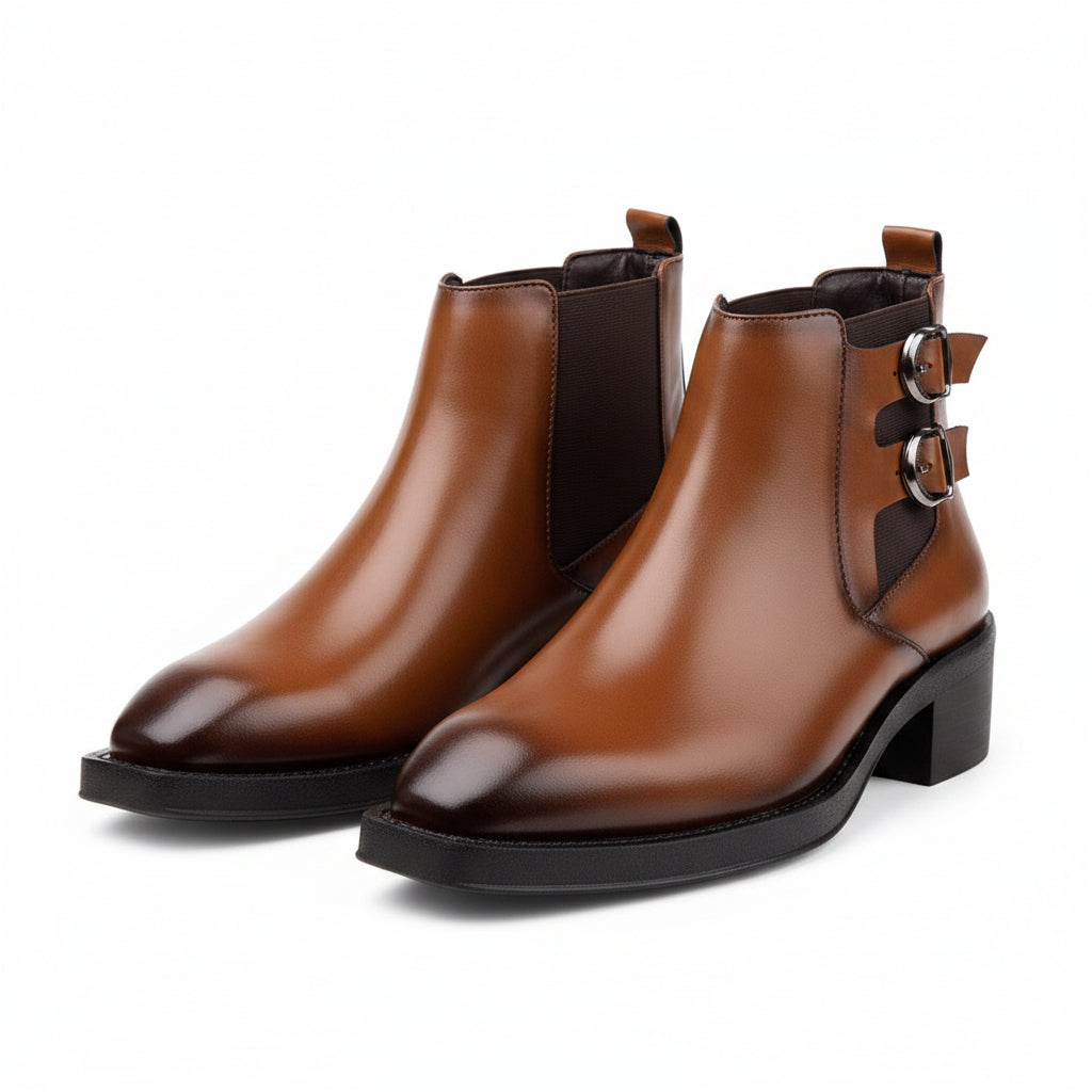 Brown leather ankle boot with decorative buckles on a white background