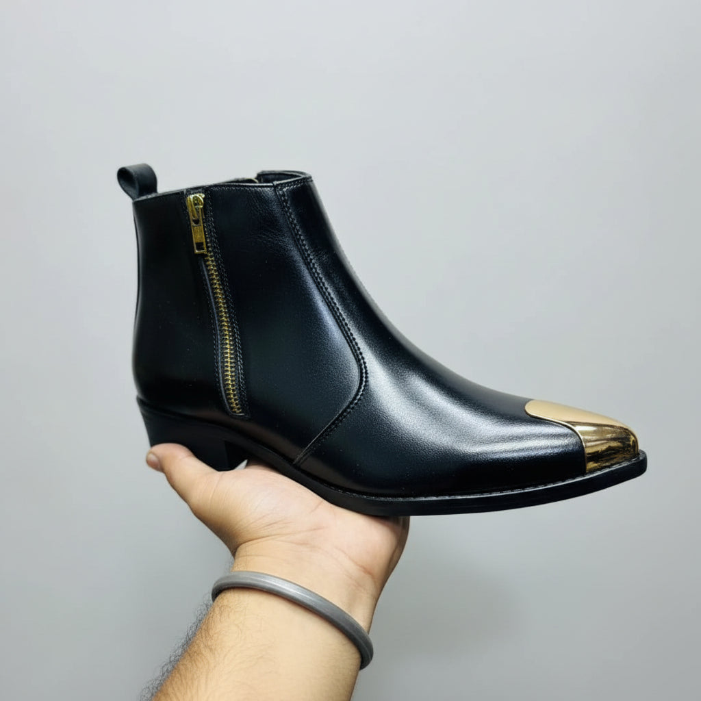 Black leather boot with colorful sole held by a hand against a yellow background