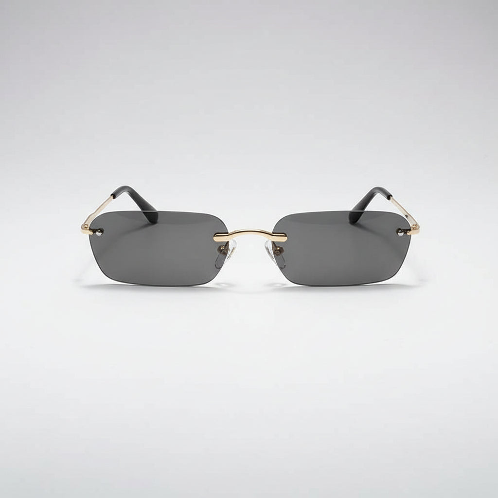 Rimless square sunglasses with dark gray lenses, a gold metal bridge, and black temple arms on a white background.
