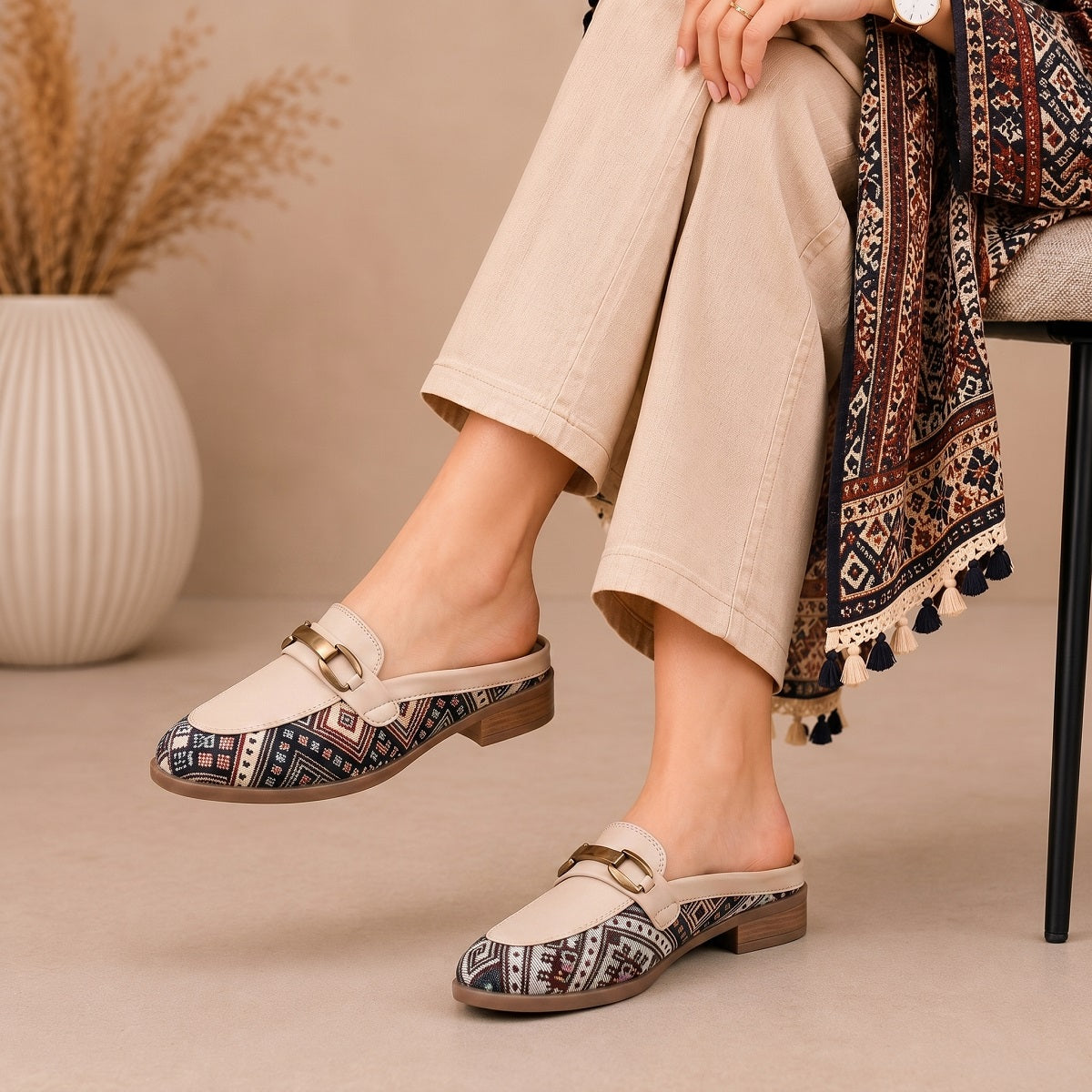Person wearing patterned loafers on a beige background