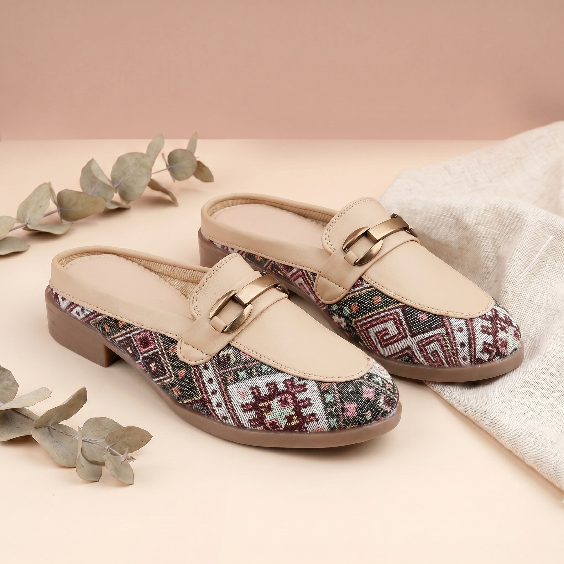 Pair of loafers with patterned soles on a light background