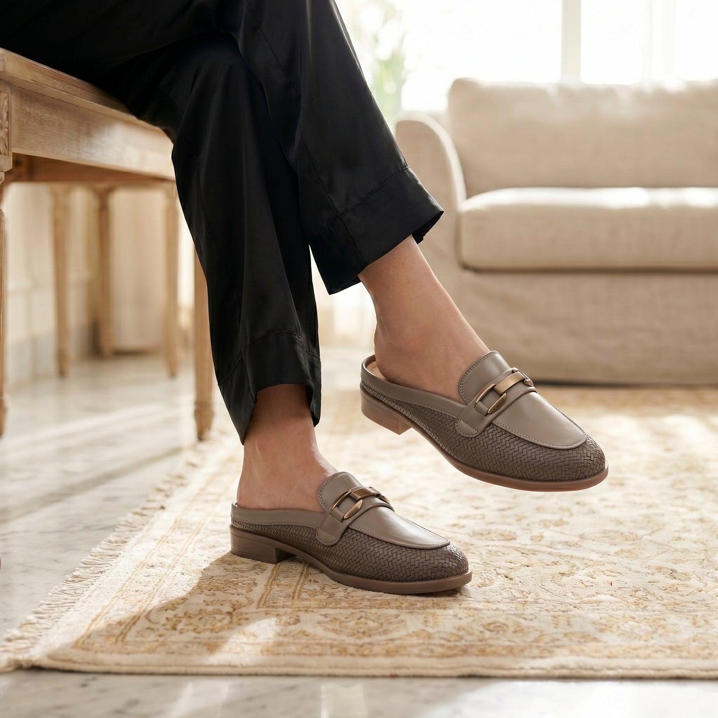 Person wearing brown loafers in a home setting