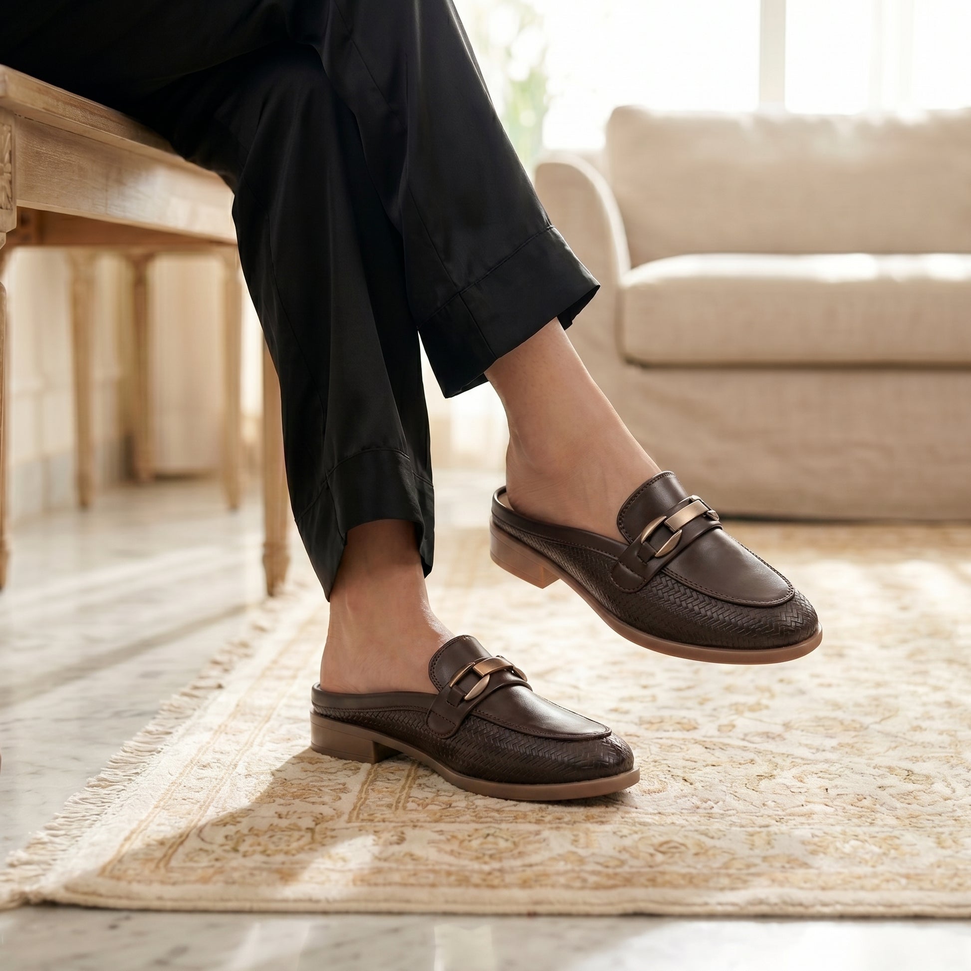 Person wearing brown loafers in a home setting