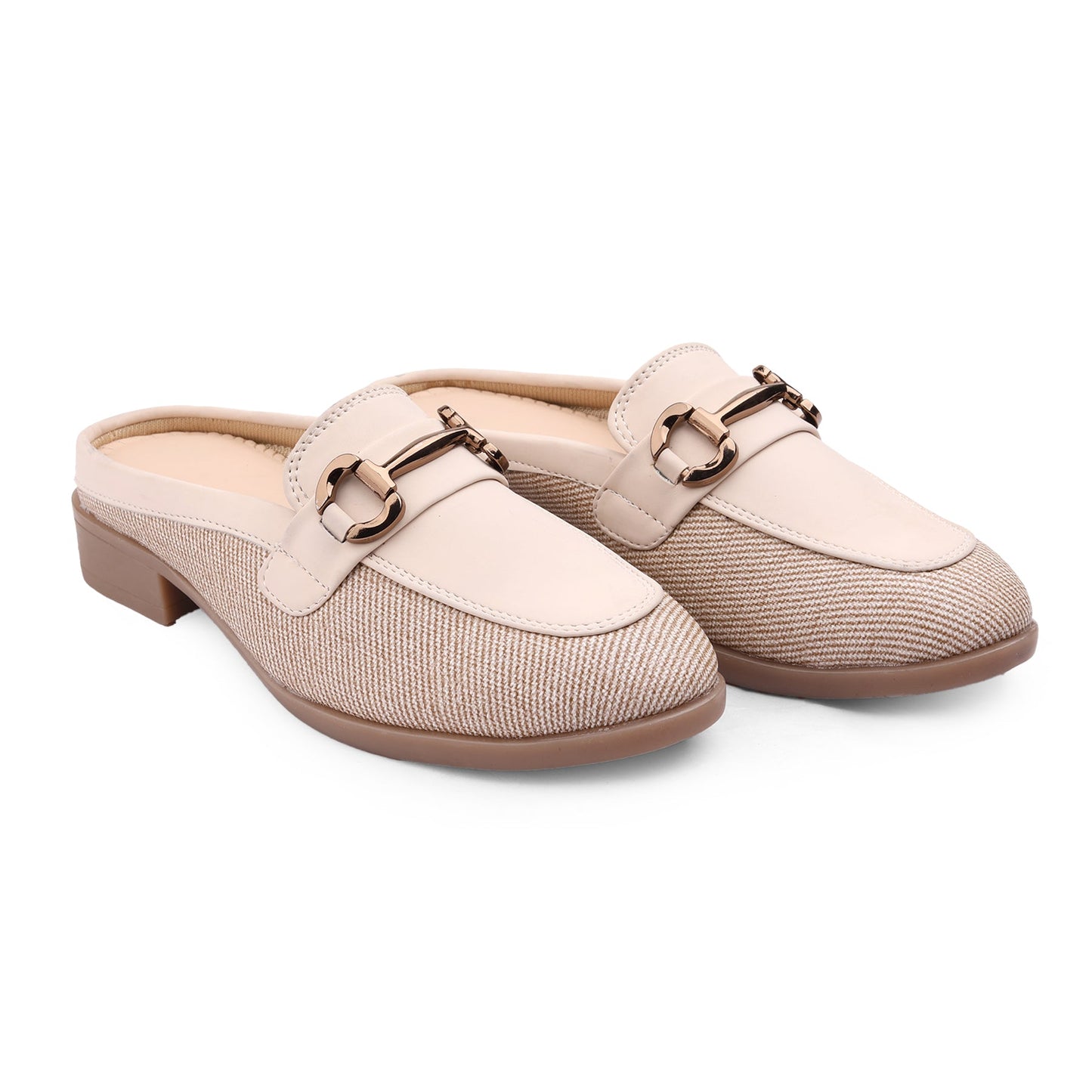 Pair of beige slip-on shoes with a decorative buckle on a white background