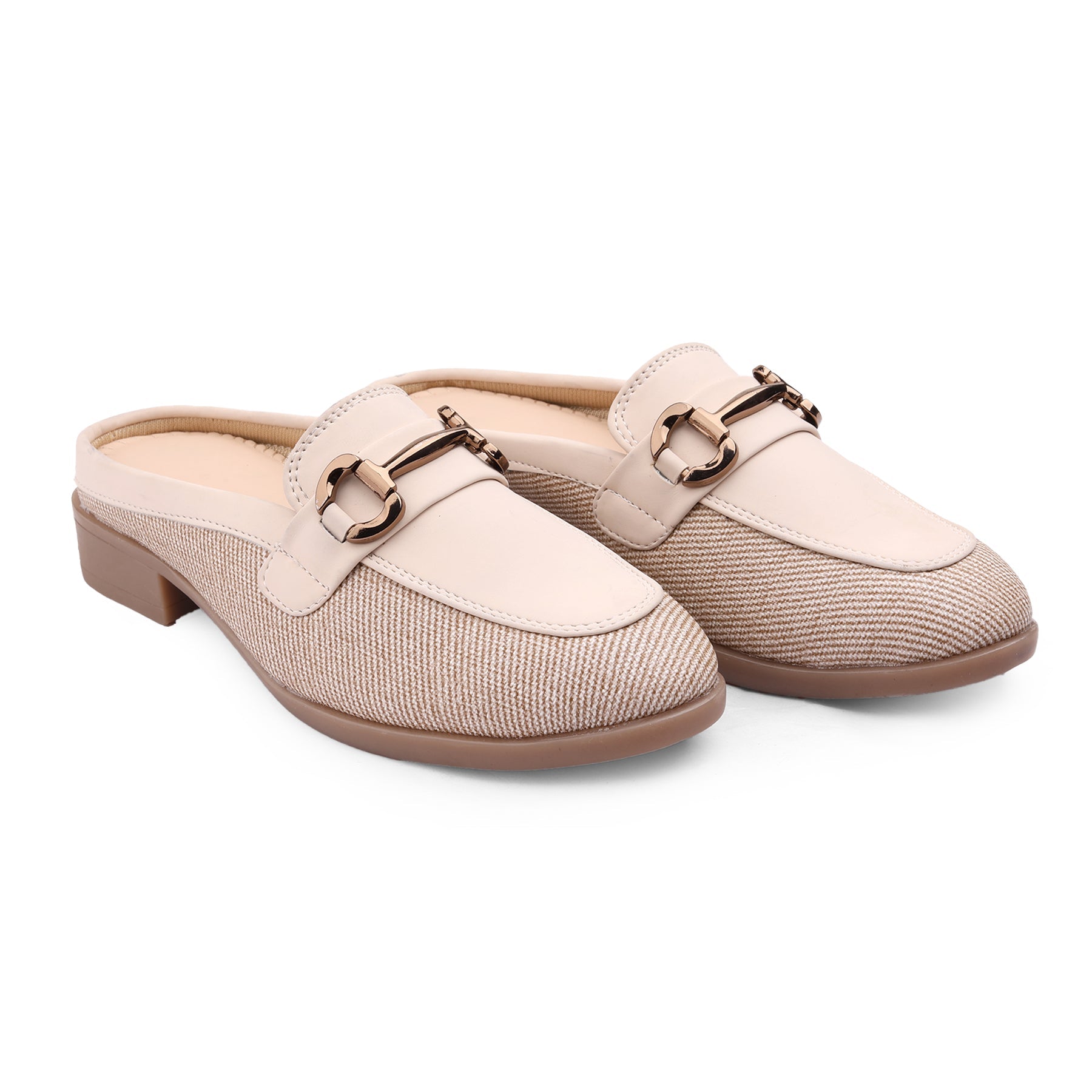 Pair of beige slip-on shoes with a decorative buckle on a white background