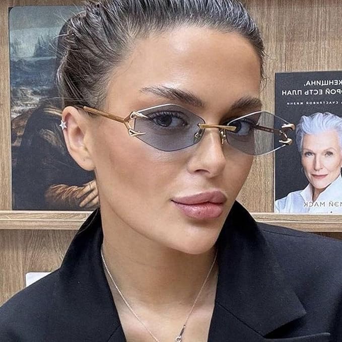 Woman wearing gold-framed sunglasses with a blurred background