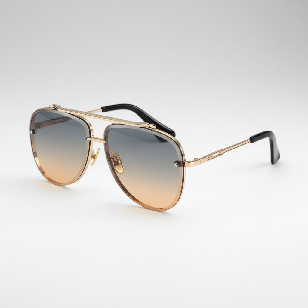 A pair of aviator-style sunglasses with a gold-tone metal frame, gradient gradient lenses that fade from gray at the top to beige at the bottom, and black temple tips, shown on a plain white background.