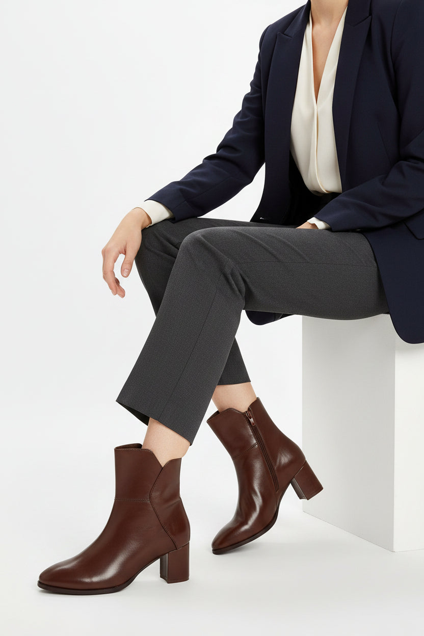 A single dark brown leather ankle boot with a block heel and rounded toe, shown from a side profile on a white background.